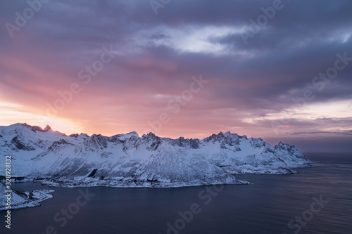 Panorama of snowy fjords and mountain range, Senja, Norway Amazing Norway nature seascape popular tourist attraction. Best famous travel locations. beautiful sunset within the amazing winter landscape