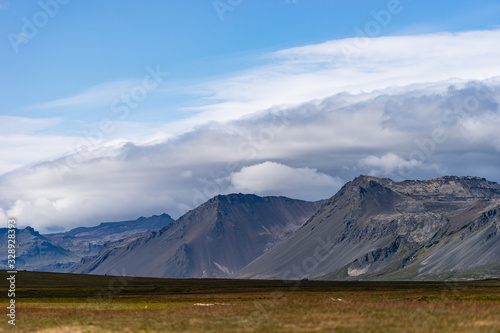 Icelandic landscape with mountains, blue sky and green grass on the foreground. West fjord part © Hladchenko Viktor