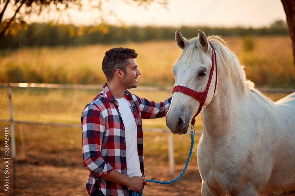 Obraz premium Loving tender moment between men and horse.Young man and horse.