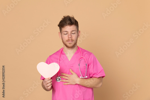African doctor wearing a pink uniform on a yellow background