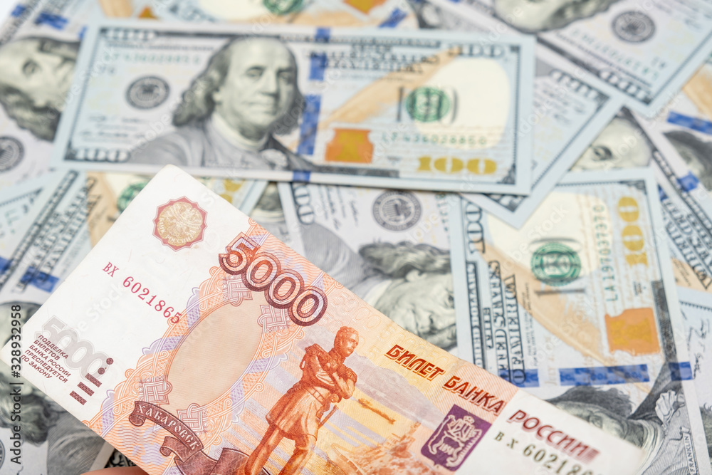 5000 rubles banknote lying on us dollar background, financial crisis concept 5000 rubles banknote lying on us dollar background, financial crisis concept