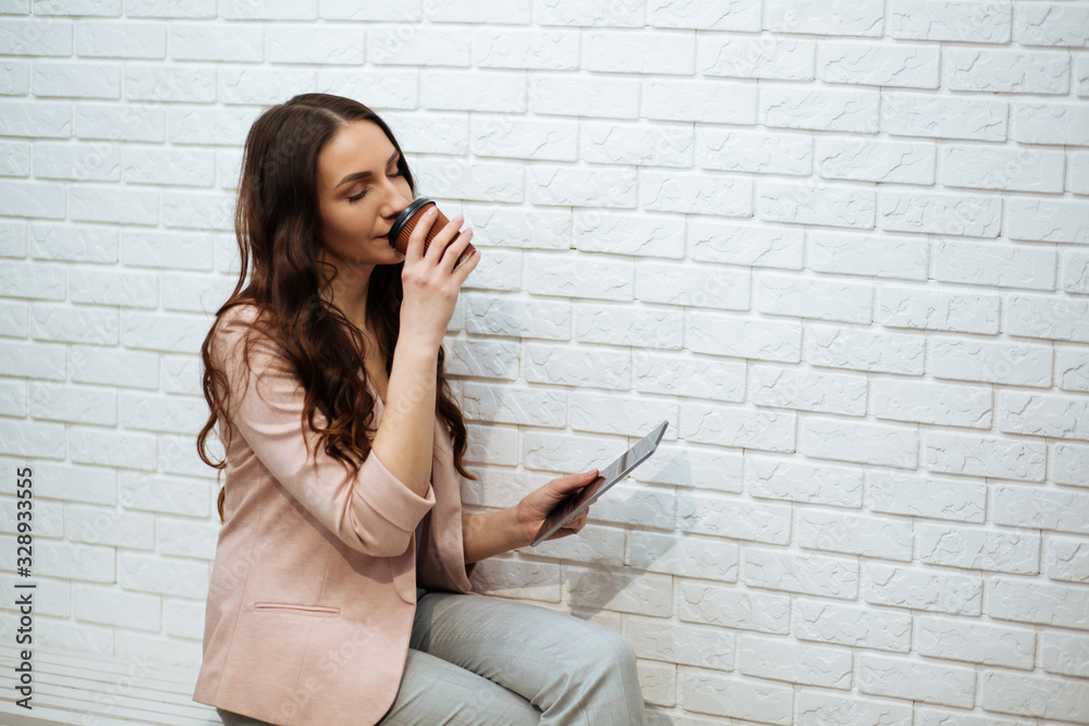 business woman holding tablet and drinking coffee business woman holding tablet and drinking coffee