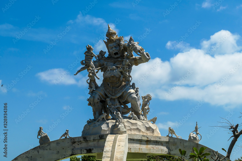 A close up on an ornated roof of Uluwatu temple, Bali Indonesia. It represents a monkey king fighting with smaller monkeys and other creatures. Hinduism. Traditional and cultural site