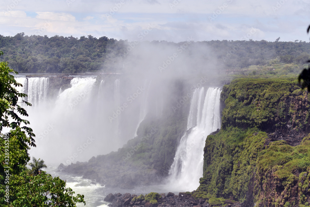 Iguazu roaring waterfalls against a jungle and gray sky Iguazu roaring waterfalls against a jungle and gray sky