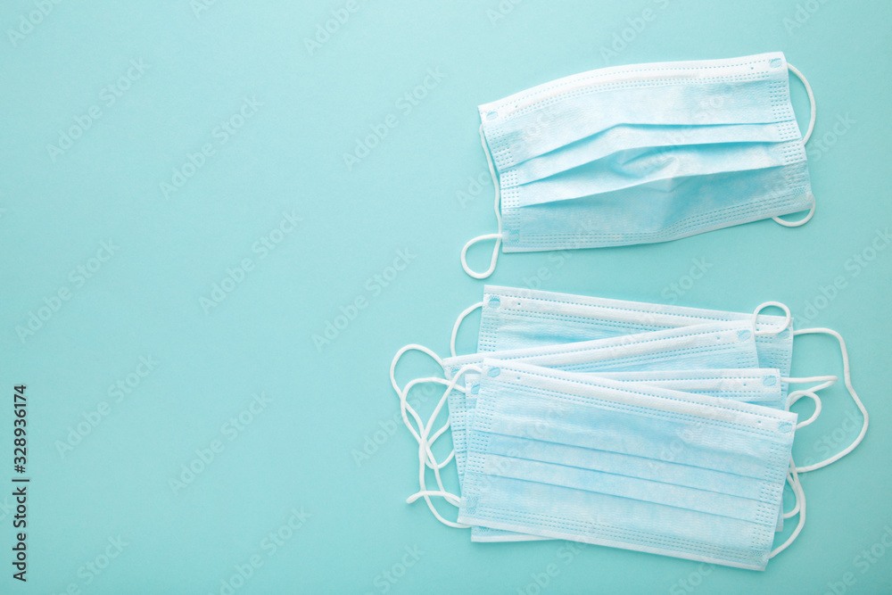 Medical masks on a blue background with copy space. Coronavirus