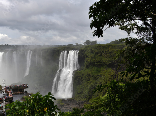 Iguazu roaring waterfalls against a jungle and gray sky