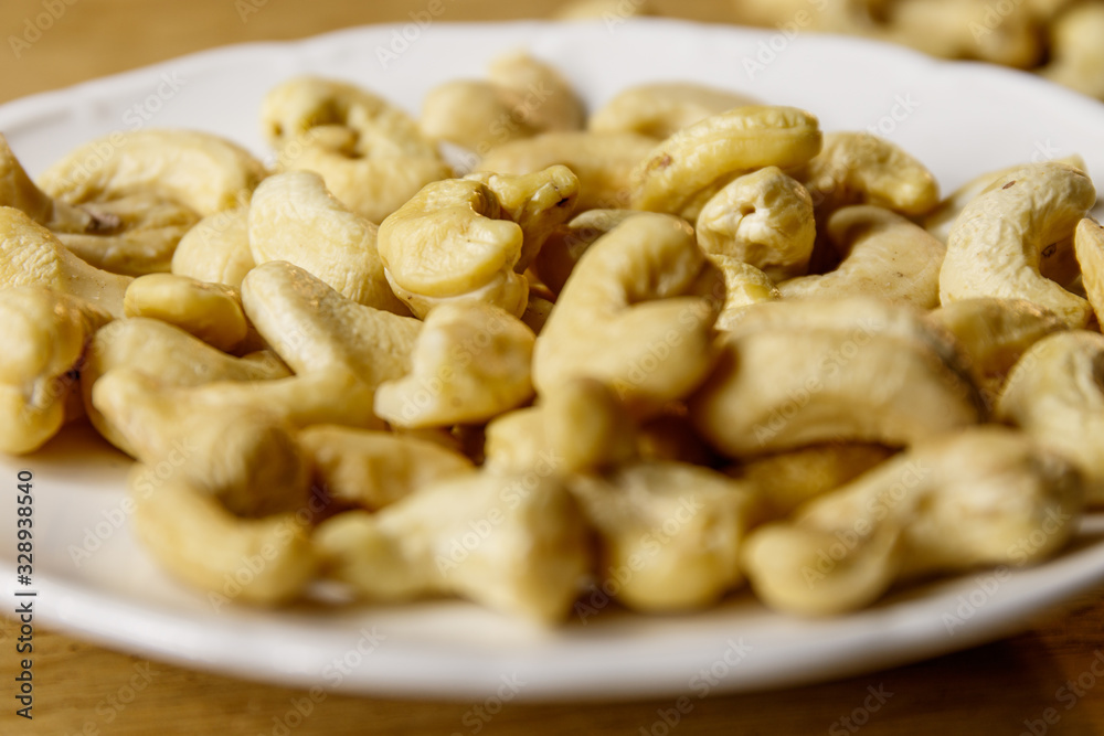 Cashew nuts. The cashew tree is a tropical evergreen tree that produces the cashew seed and the cashew apple.