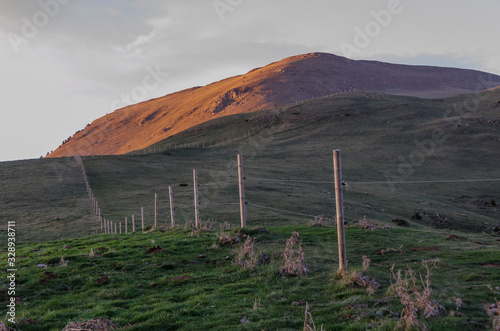 Paisaje de prado alpino estepario de la montaña del Taga en Cataluña al amanecer con valla delimitadora. photo