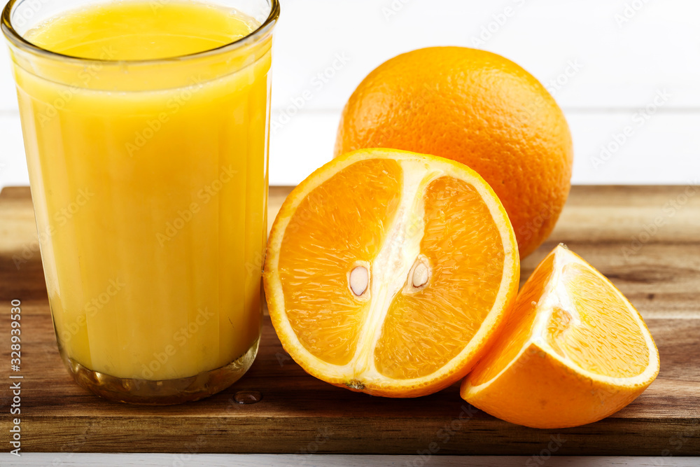 glass of juice and oranges glass of juice and oranges