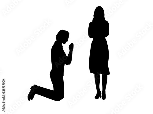 Silhouette of man beg on his knees in front of woman