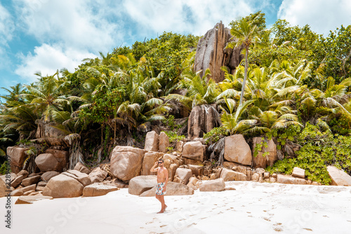 Seychelles tropical Island, Young man on the white beach during Holiday vacation Mahe Seychelles, Praslin Seychelles photo