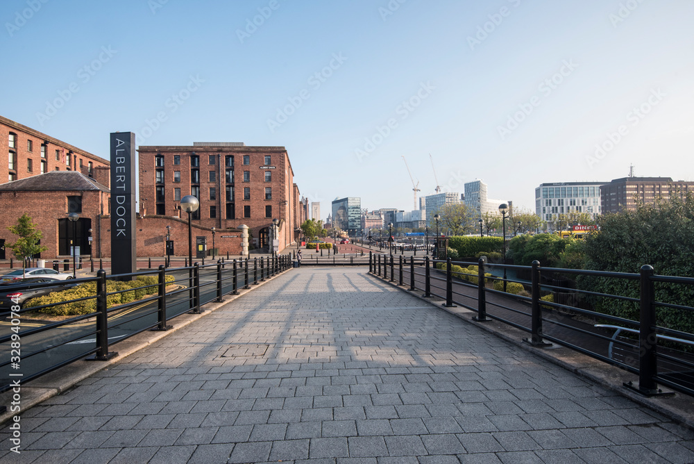 The Albert Dock area of Liverpool just after sunrise, with low sun and long shadows