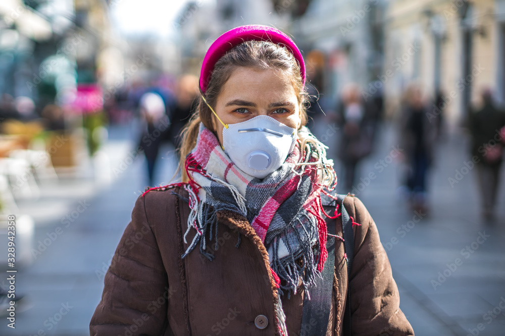 young woman wearing a mask to protect from viruses and pollution young woman wearing a mask to protect from viruses and pollution