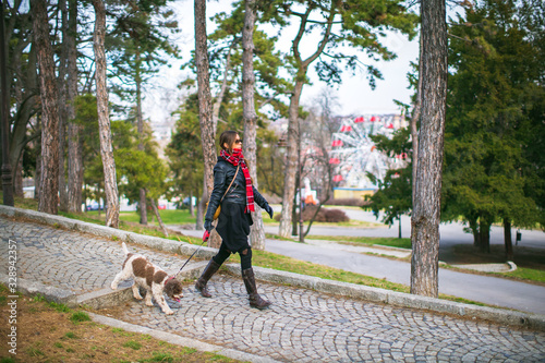 young woman taking her dog for a walk