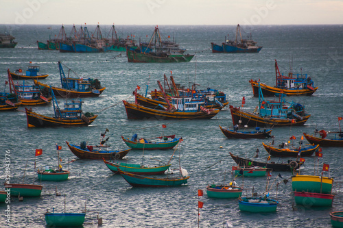 Viatnam Muine fishing village. A lot of boats on sunset background. photo