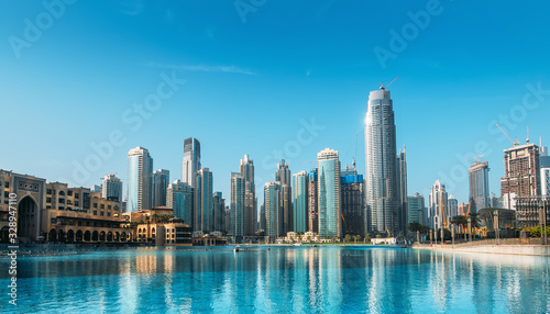 Downtown Dubai district skyline panorama with high rise buildings reflected in pool water. United Arab Emirates, UAE. © DedMityay