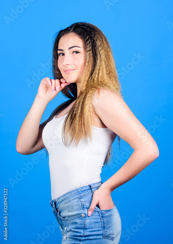 Hair crimping method styling hair becomes wavy. Fashion model. Hairdresser salon. Damaged hair. Extra volume. Styling cosmetic product. Crimped hairstyles. Woman stylish hairstyle on blue background