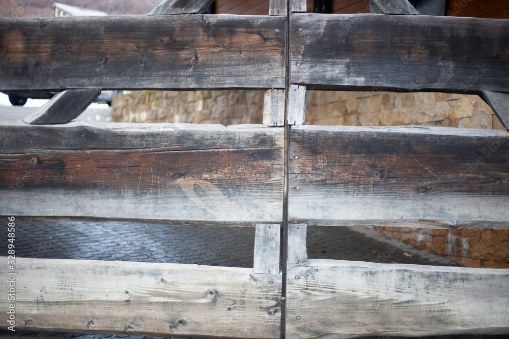 Wooden gate to the countryside. The fence on the farm. The construction of the boards. Check in for the car. Gate for cattle. Wooden gate to the countryside. The fence on the farm. The construction of the boards. Check in for the car. Gate for cattle.