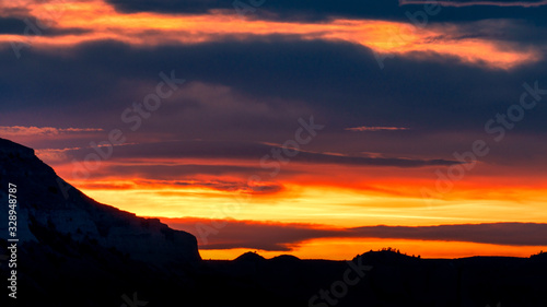 Dramatic sunset clouds over mountain silhouette