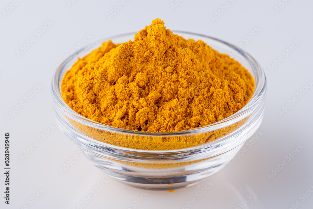 natural turmeric powder on white acrylic background natural turmeric powder on white acrylic background