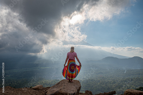 Frau beobachtet das Tal mit Vulkan im Hintergrund