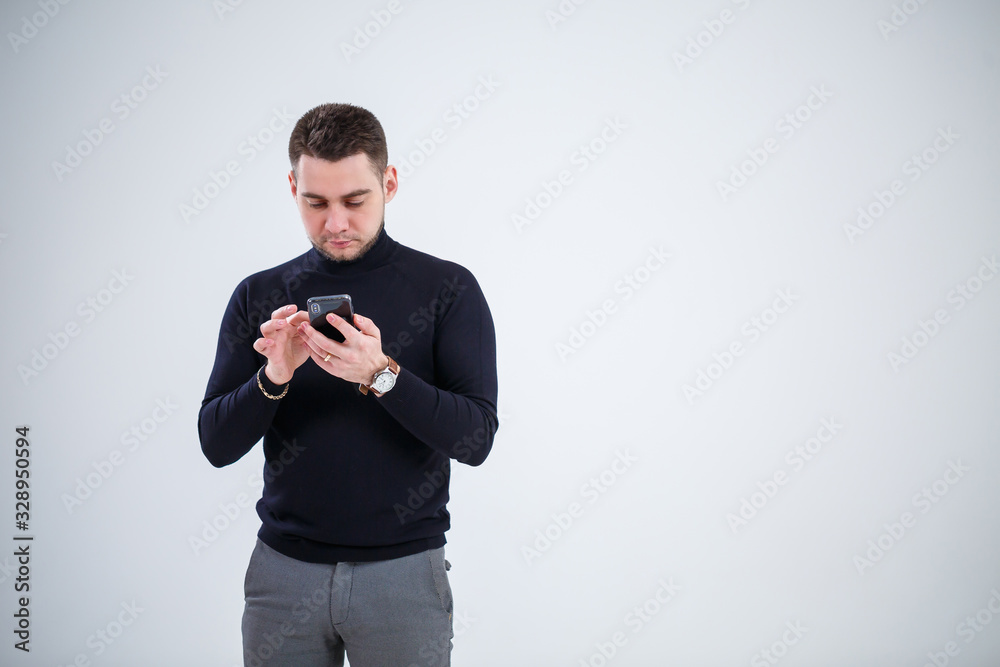 Serious guy businessman in black clothes finds out important questions by phone. Working day concept Serious guy businessman in black clothes finds out important questions by phone. Working day concept