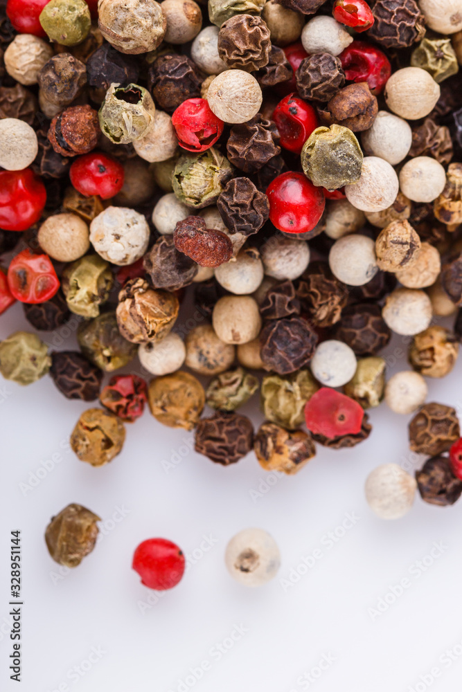 mix of peppercorns on white acrylic background mix of peppercorns on white acrylic background