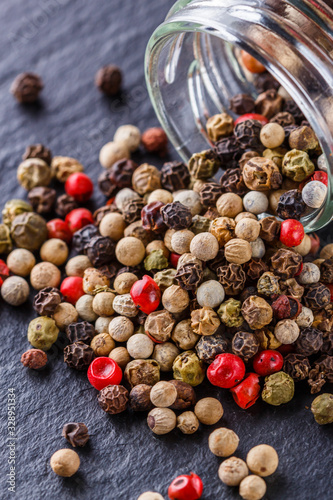 mix of peppercorns on a dark stone background