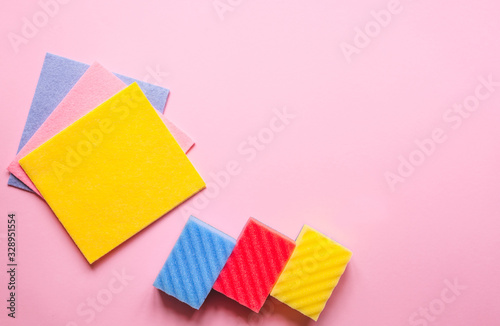 Slika na platnu Pastel pink table cleaning background with rag and rubber protective gloves for different surfaces cleaning in kitchen, bathroom and other rooms