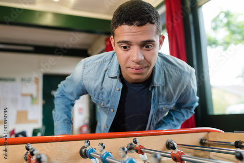 young man playing table football