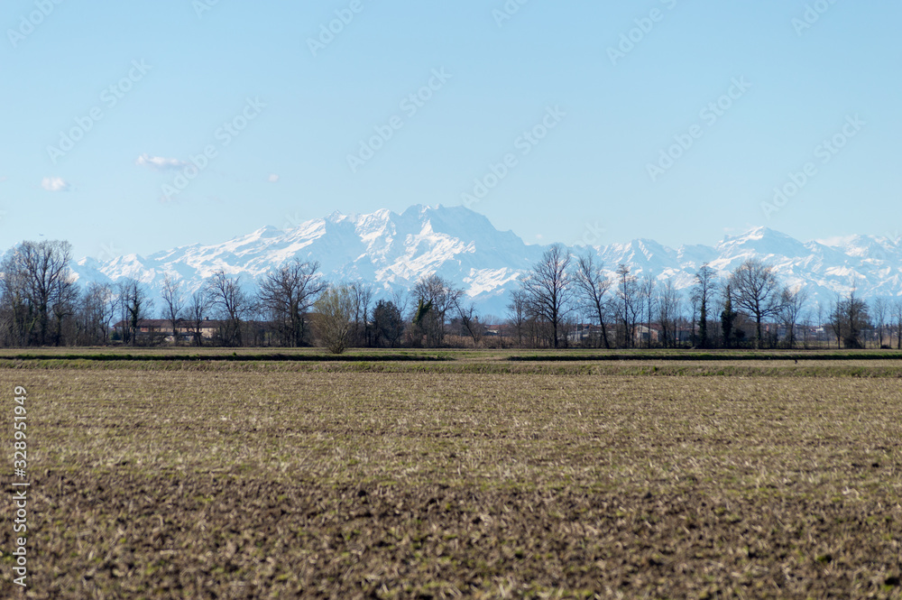 Farming landscape with the wonderful Alps mountains in the background in northern Italy just outside Milan Farming landscape with the wonderful Alps mountains in the background in northern Italy just outside Milan