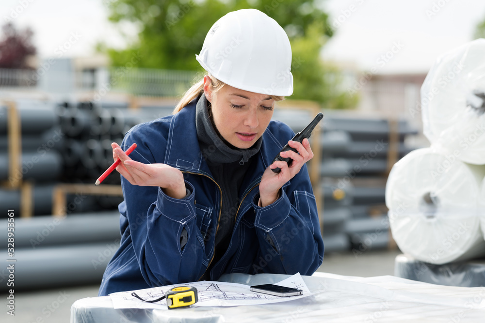 a female engineer using walkie-talkie a female engineer using walkie-talkie