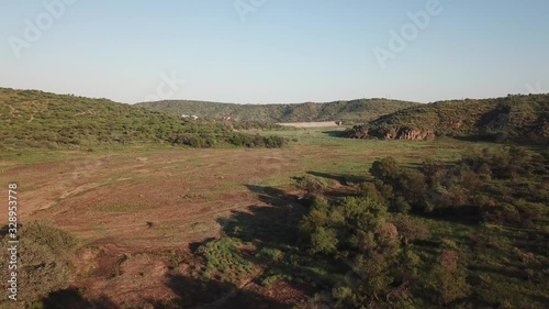 4K aerial drone video of greeen savanna hills and Avis Dam near historical railway bridge on main B6 road from Windhoek to Gobabis in central highland Khomas Hochland of Namibia, southern Africa photo