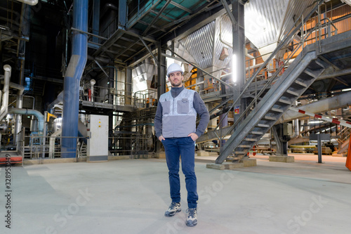 full length portrait of male worker in factory