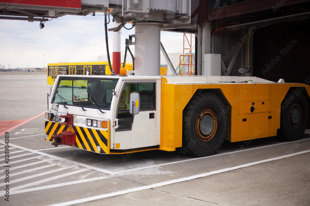 Special vehicles on the runway. Loader at the airport. A special machine for moving an airplane. Security at the airport is ensured by appliances.