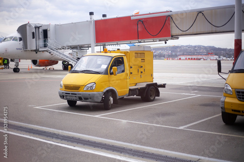 Special vehicles on the runway. Loader at the airport. A special machine for moving an airplane. Security at the airport is ensured by appliances.