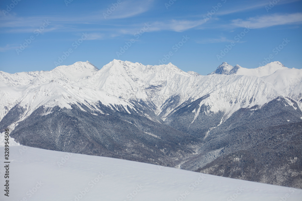Mountain landscape with snow. Snow-capped peaks of the mountains. High altitude. Background of calm mountains. Sunny weather in the highlands.