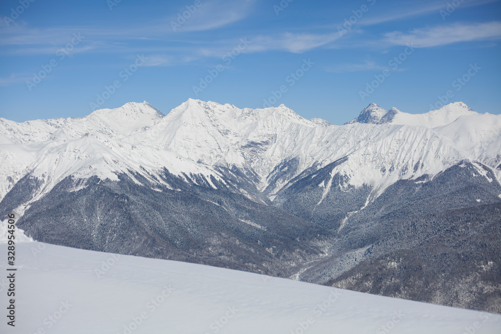 Fototapeta premium Mountain landscape with snow. Snow-capped peaks of the mountains. High altitude. Background of calm mountains. Sunny weather in the highlands.