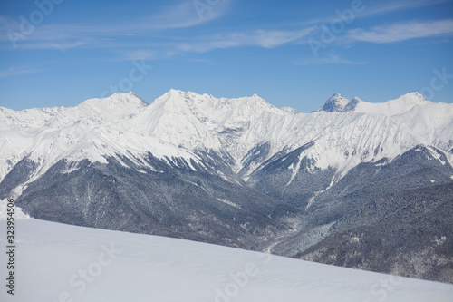 Mountain landscape with snow. Snow-capped peaks of the mountains. High altitude. Background of calm mountains. Sunny weather in the highlands. © Олег Копьёв