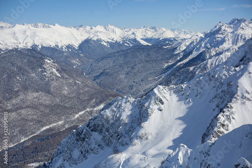 Mountain landscape with snow. Snow-capped peaks of the mountains. High altitude. Background of calm mountains. Sunny weather in the highlands.