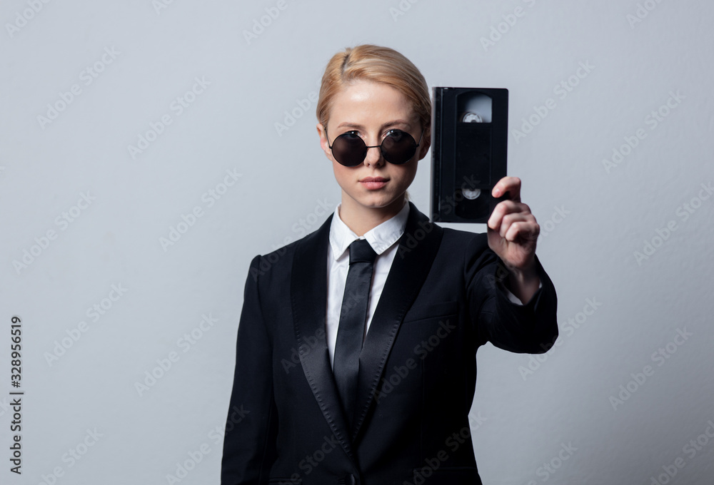 businesswoman in sunglasses with video tape businesswoman in sunglasses with video tape