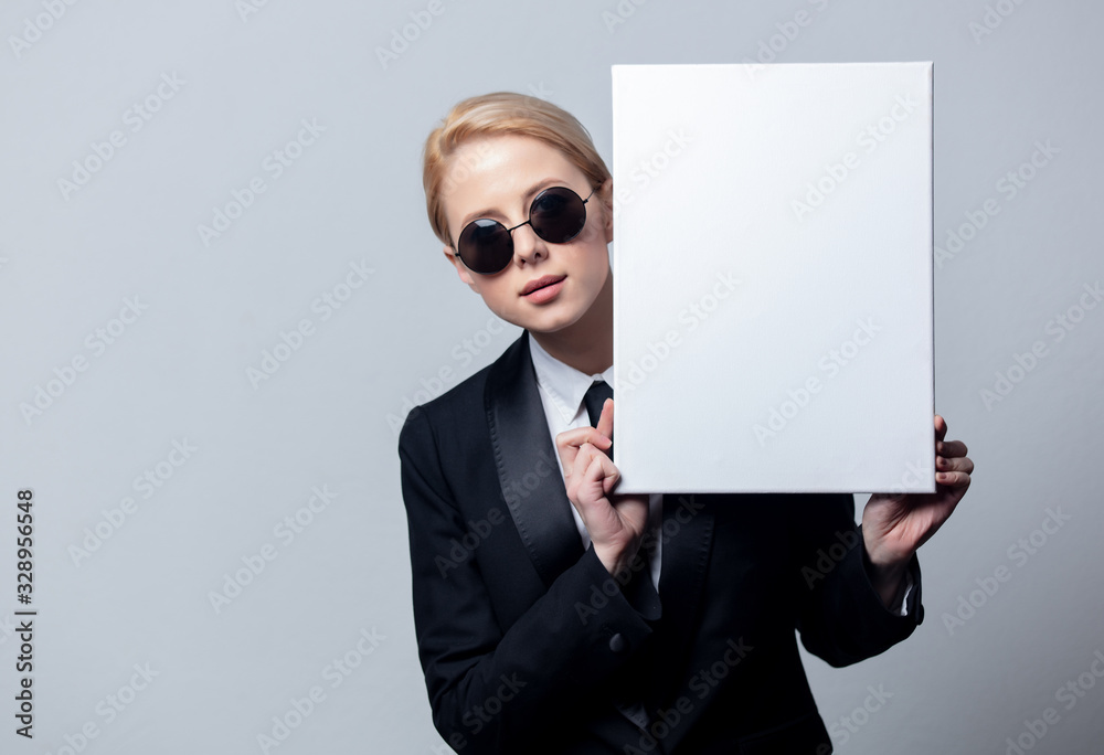 businesswoman in sunglasses with white board businesswoman in sunglasses with white board
