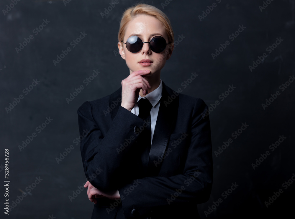Style businesswoman in a classic black business suit and sunglasses Style businesswoman in a classic black business suit and sunglasses