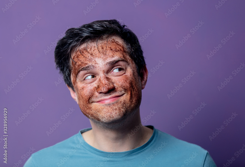 smiling guy in a face care mask smiling guy in a face care mask