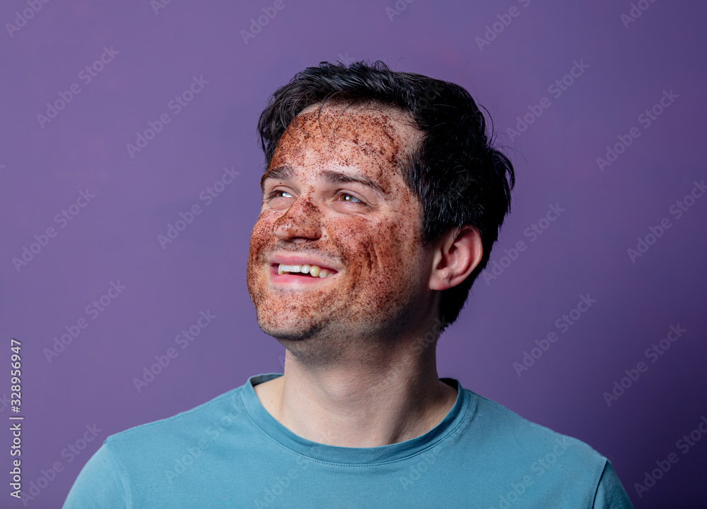 Fototapeta premium smiling guy in a face care mask