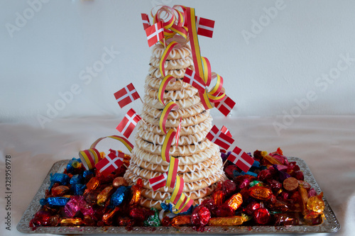 Traditional Scandinavian tower cake (kransekake) made from baked marzipan, decorated with icing