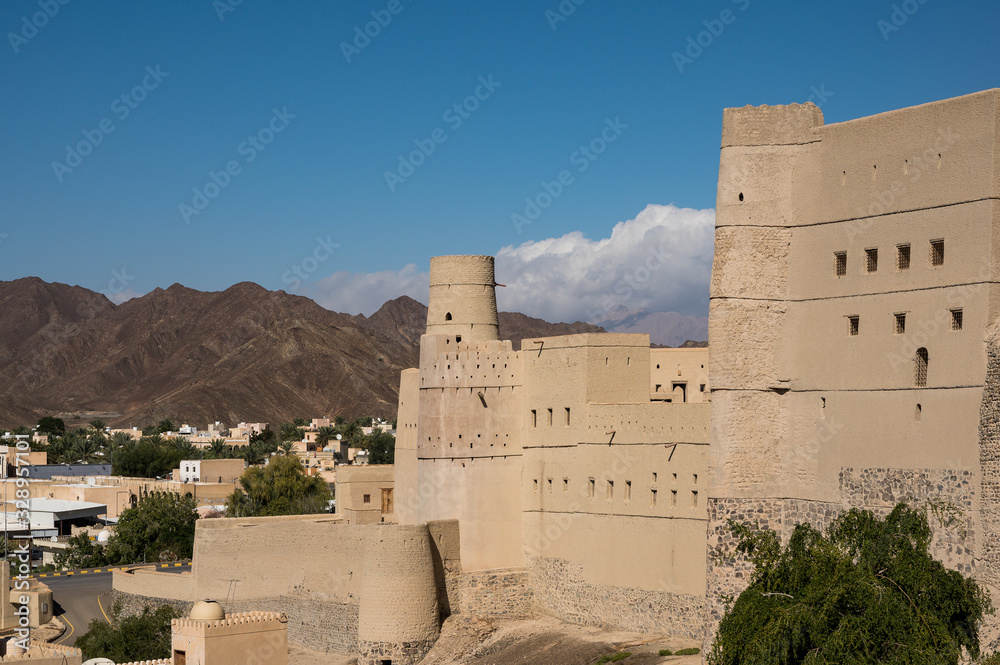 Antique Bahla fort with high mountains on the background in Oman