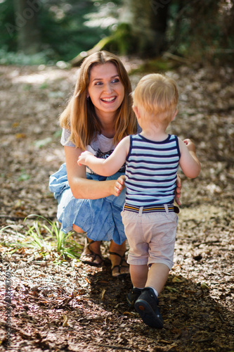 Happy mother and little son having great time together in the park. Mothers day emotional concept.
