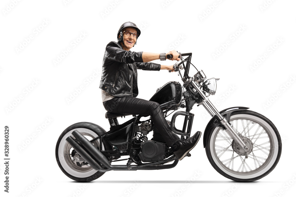 Elderly man riding a customized chopper motorbike Elderly man riding a customized chopper motorbike