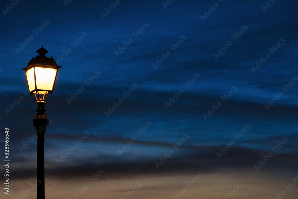 Old fashioned street lamp against blue hour sunet sky (with copy space)
